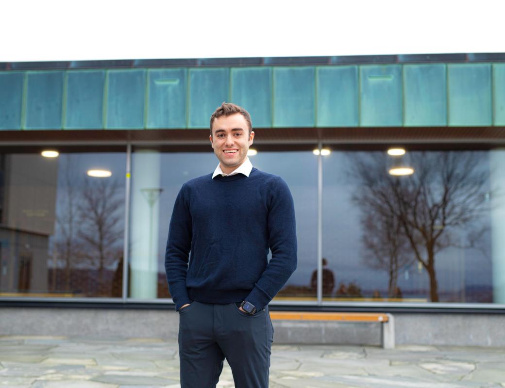 A student standing in front of NHH